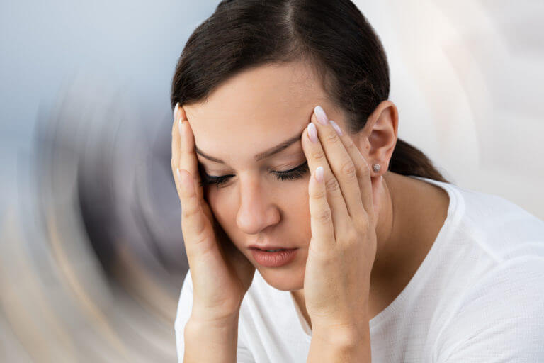 Woman suffering from vertigo