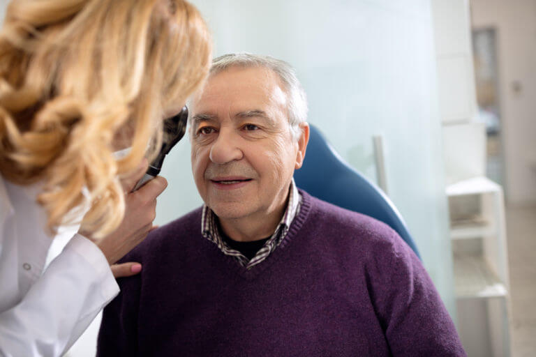 Doctor examining a male patient