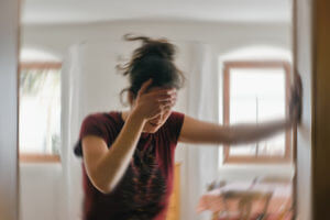 Blurred photo of woman suffering from vertigo or dizzines