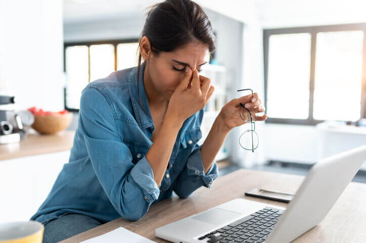 Stressed business woman working from home on laptop