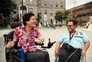 Friends living with disabilities (Cerebral Palsy) meeting in city street.